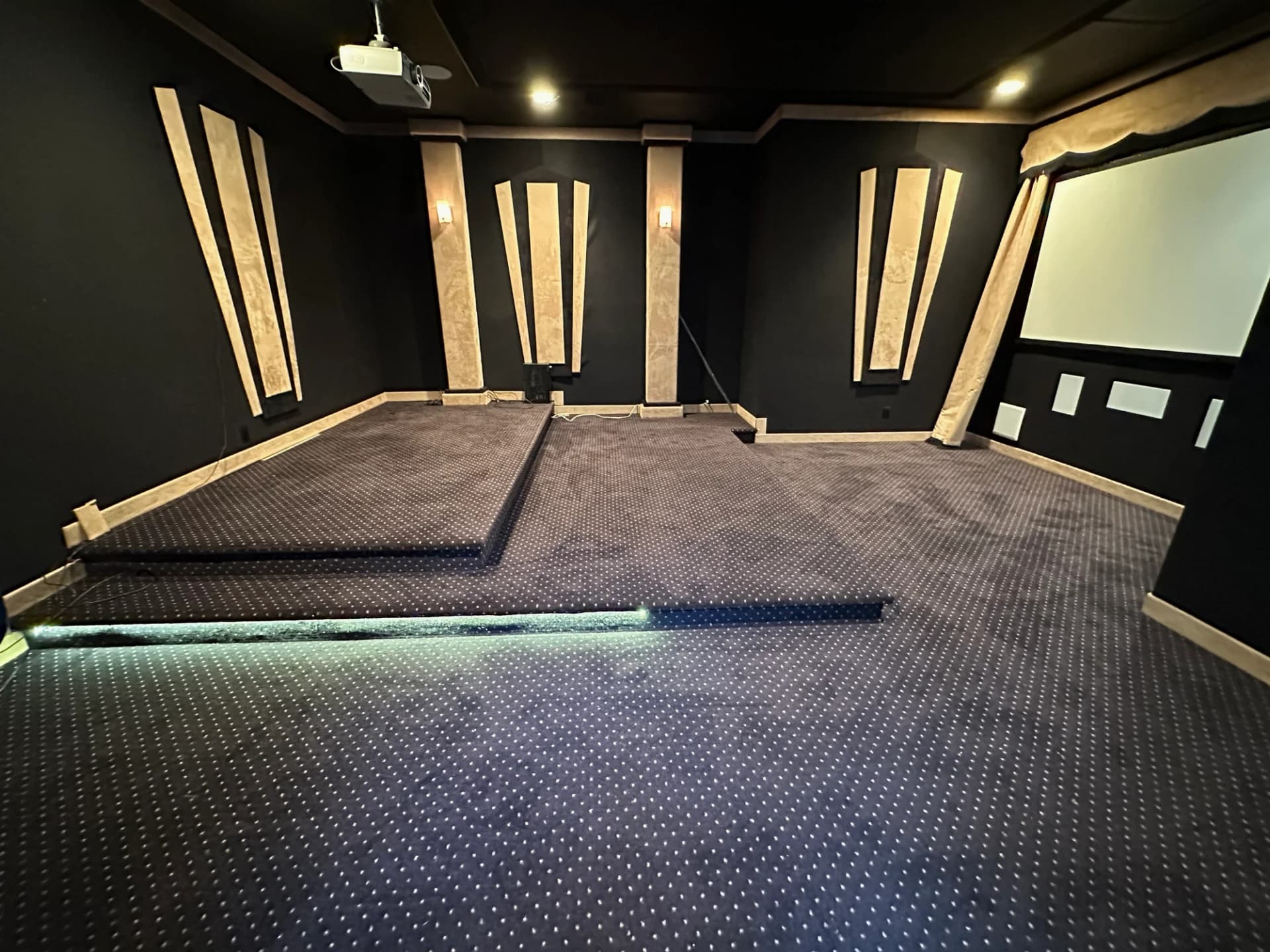 Home theater room after LA Top Clean — clean carpet, platform, and media room ready to use