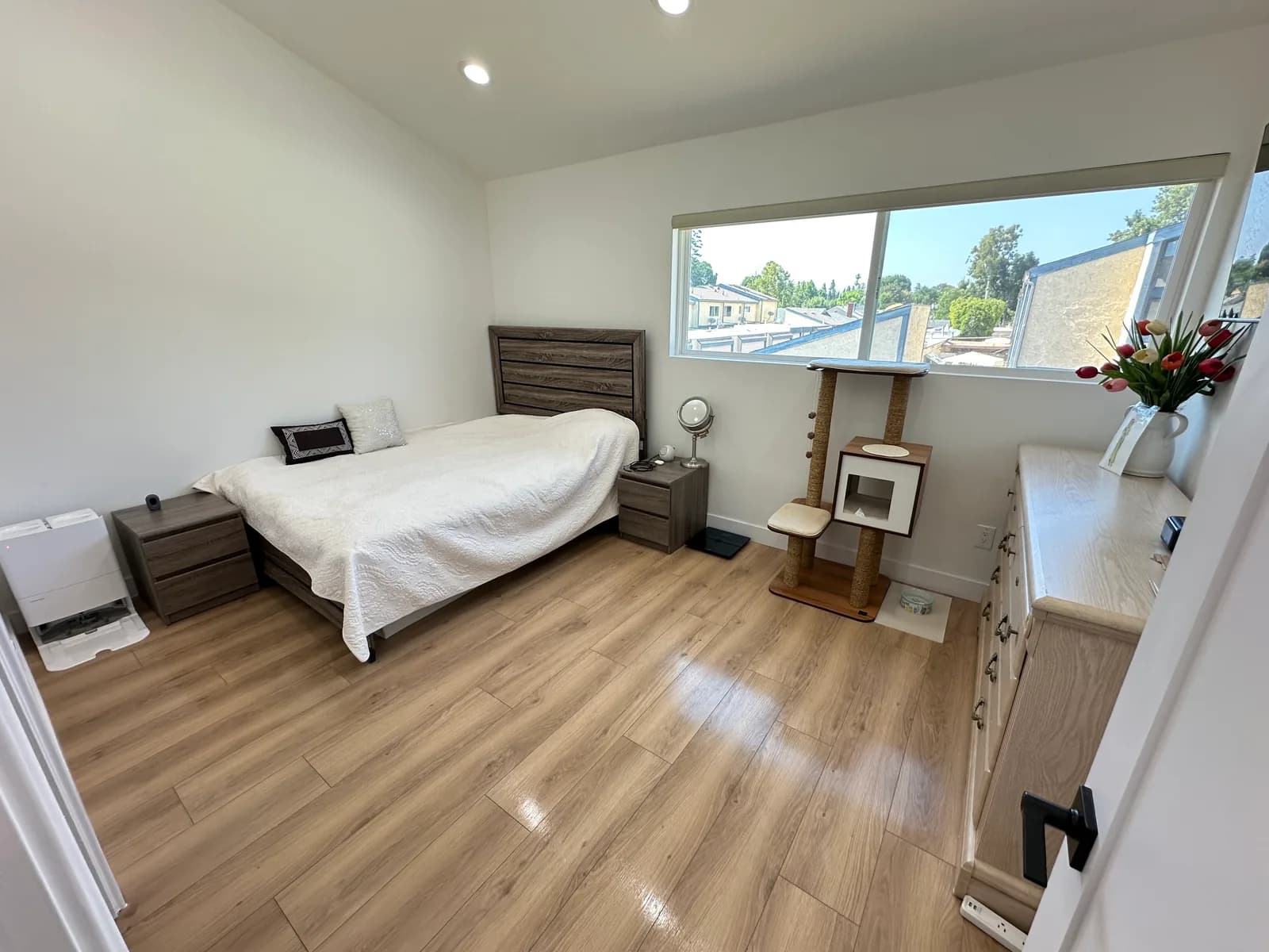 Clean modern bedroom with natural light after housekeeping service