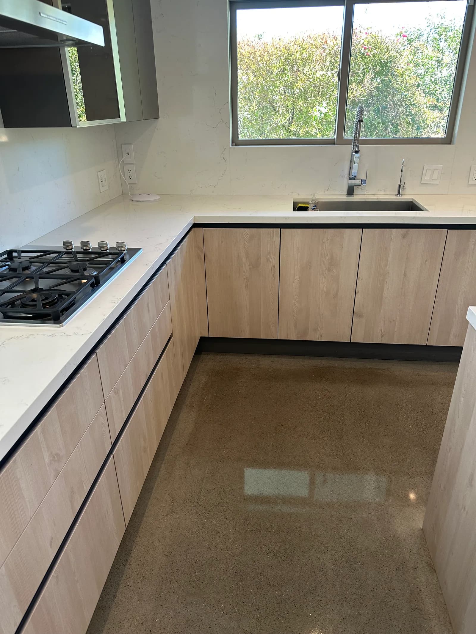 Minimalist kitchen with polished concrete floors after deep clean