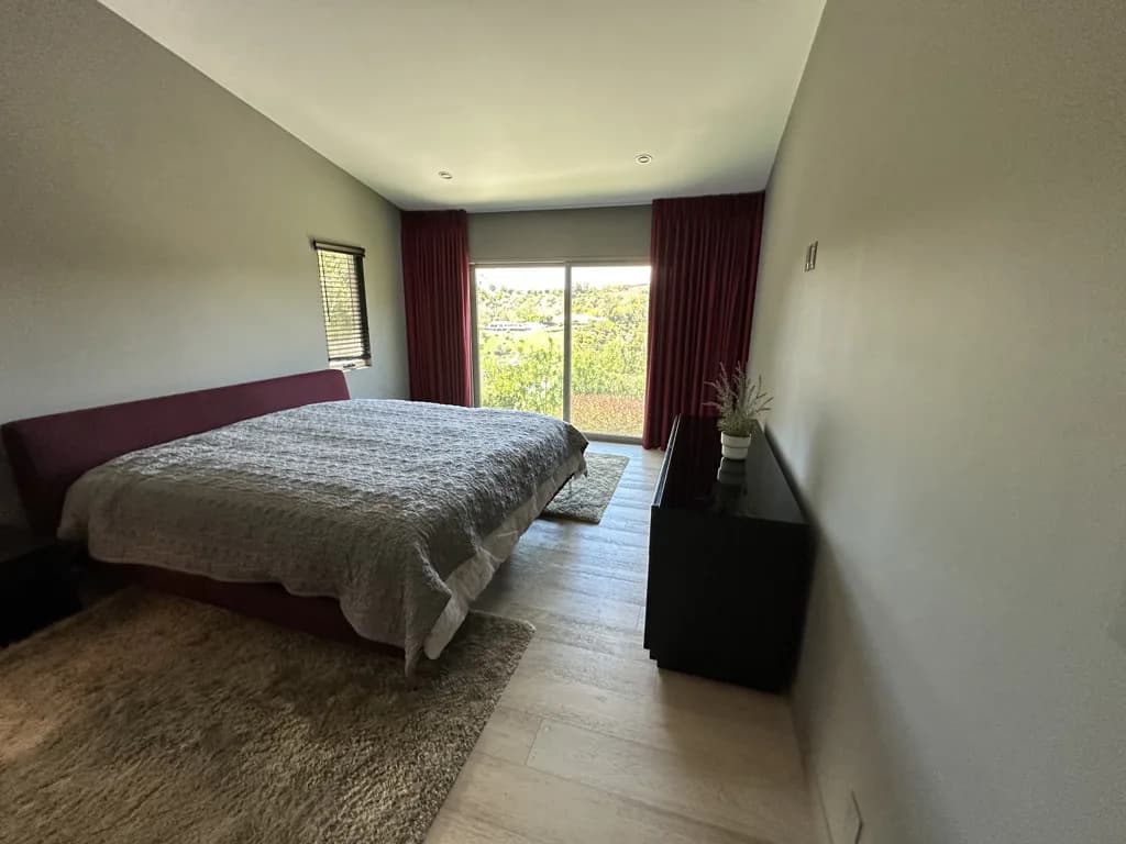Bright bedroom with floor-to-ceiling windows after residential cleaning
