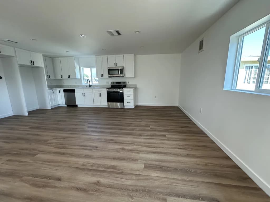Open-concept kitchen and living area after move-out cleaning