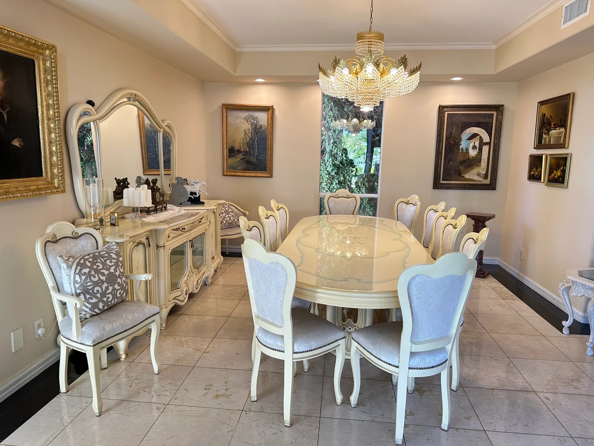 Formal dining room with marble floors, crystal chandelier, and polished table after deep cleaning