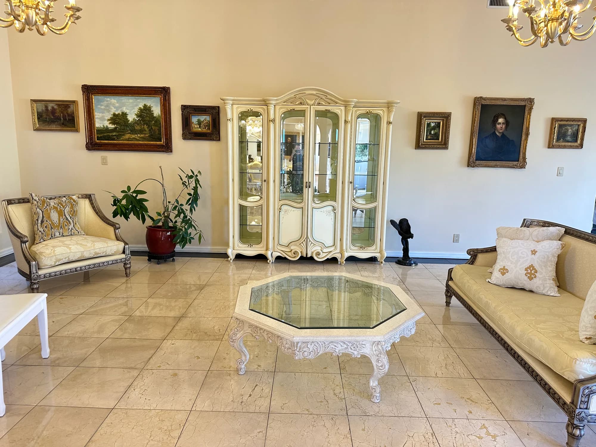 Elegant living room with marble floors, crystal chandeliers, and refreshed upholstery after professional cleaning