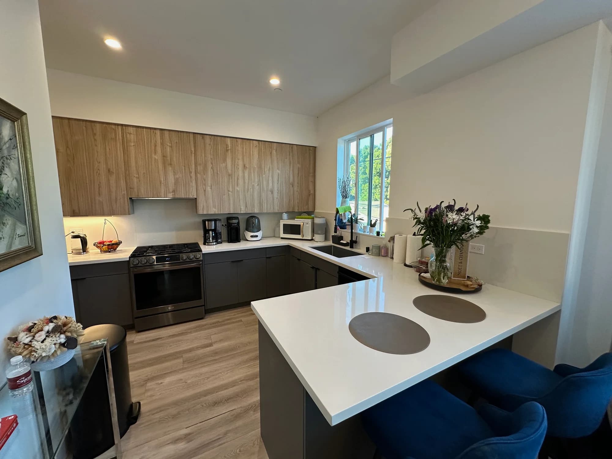 Contemporary kitchen with white island, wood cabinetry, and refreshed surfaces after cleaning